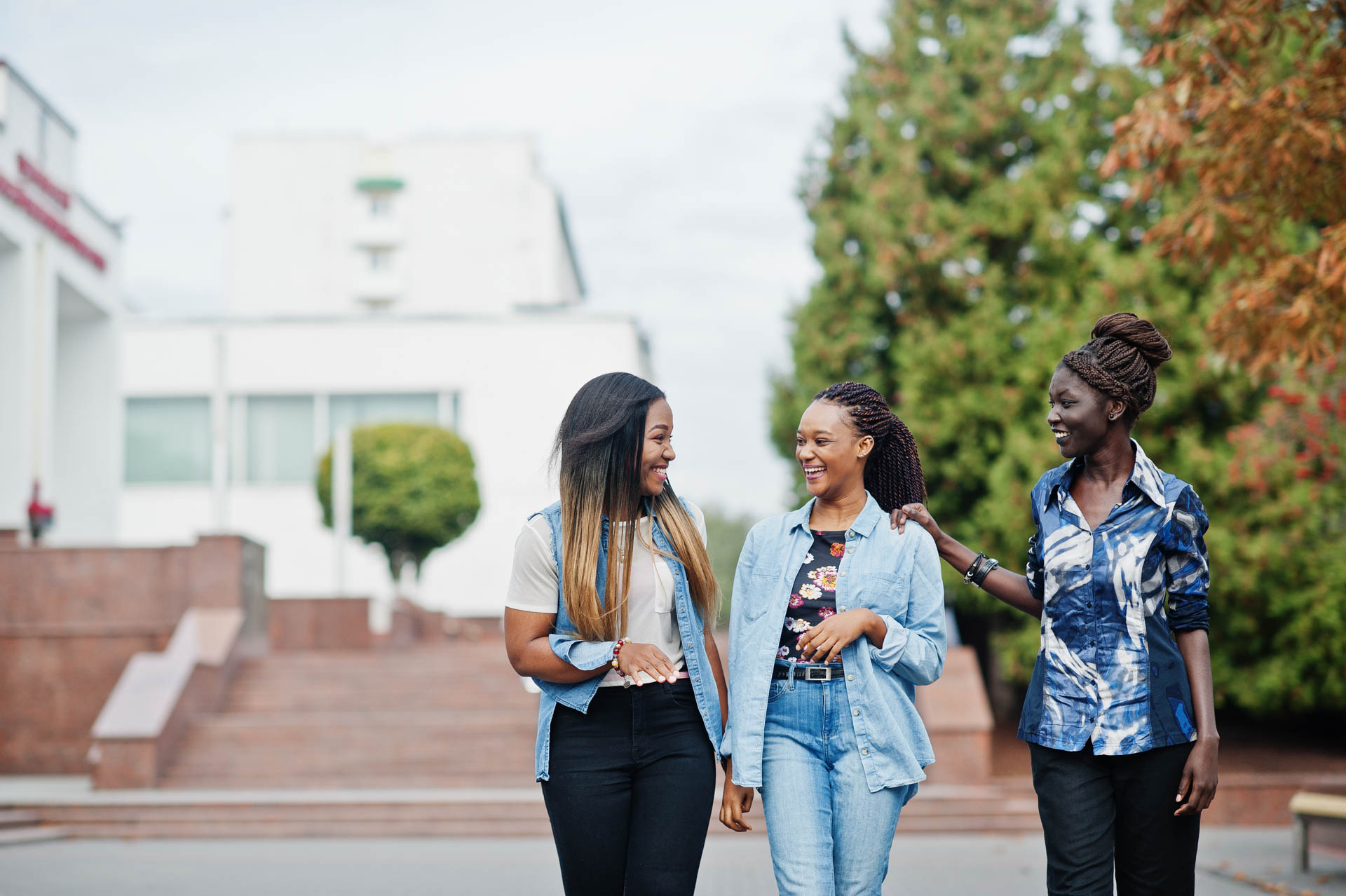 Three students walking through campus